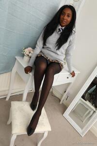 Amber Hill clad in college uniform and white teen panties under the skirt