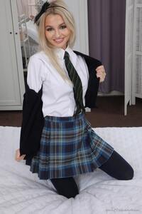 Fine looking and lewd model Anabelle poses in plaid miniskirt.