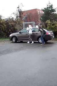 2 Gfs Piss Behind A Parked Vehicle