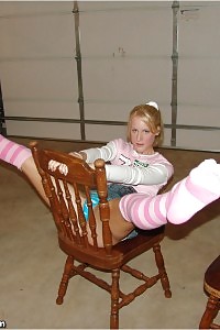 Sea Poses In The Chair As She Pulls Up Her Denim Skirt