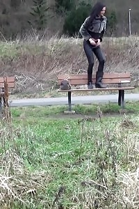 Brunette Girl Pisses On A Wooden Bench