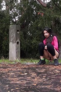 Black Haired Lass Squats To Piss On A Road