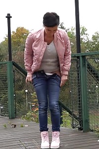 Black Haired Doll Squats To Piss On Decking